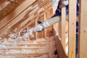 worker-sprays-bown-in-insulation-into-an-attic